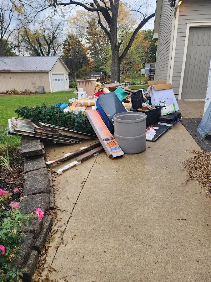Dumpster being loaded with debris for 30 Yard Dumpster Rental in Lloyd